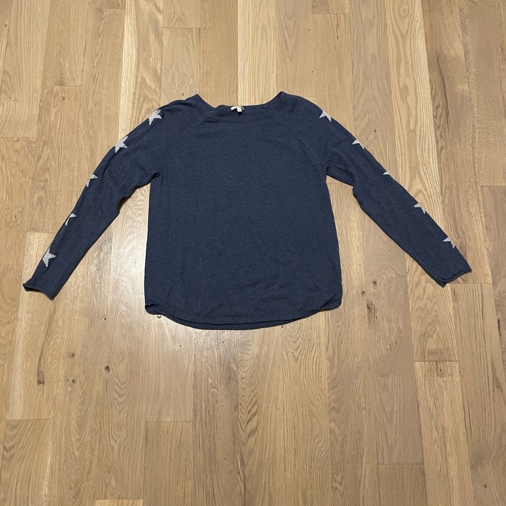 Dark blue sweater with gray stars on the side of sleeves